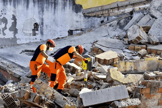 Emergency response workers conducting disaster relief operations at building collapse site