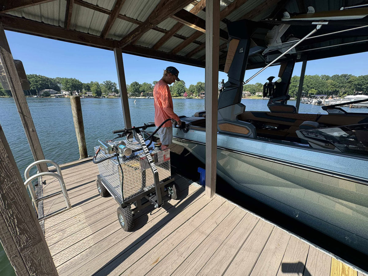 Customer fueling  a pontoon boat on Lake Norman with the Smart Ass Fuel Mule motorized gas caddy
