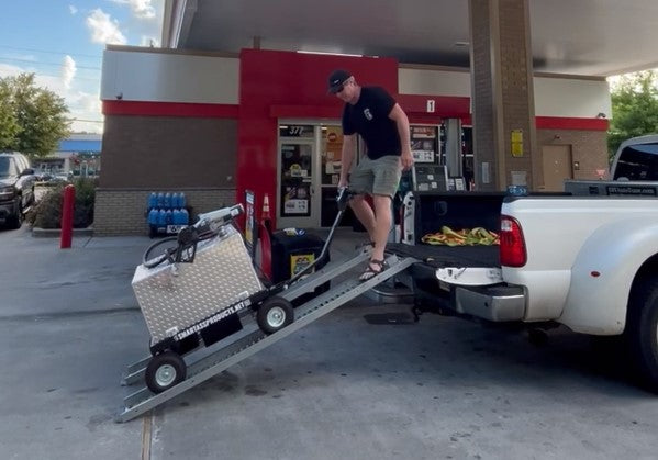 Jerry loading a Smart Ass Fuel Mule full of gasoline up ramps into the truck